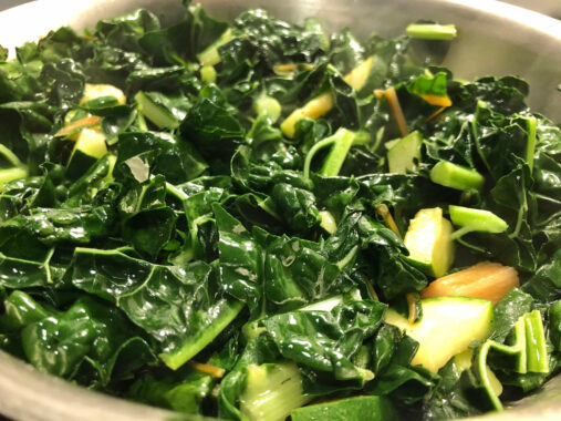 Cooking Utica Greens in a skillet.